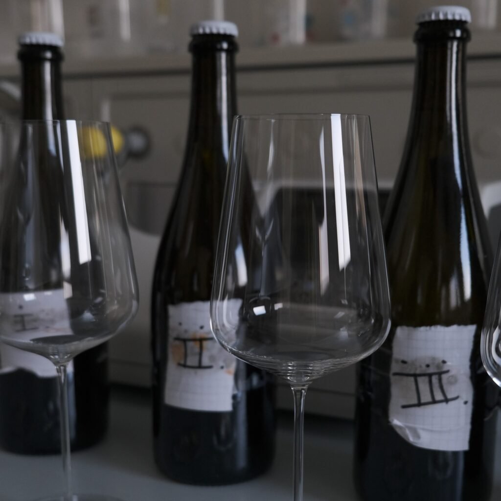Bottiglie e calici Hedera Project pronti per la degustazione in cantina